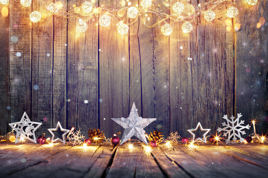Vintage Christmas Decoration With Stars And Lights On Wooden Table

