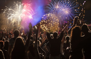 Fototapeta na wymiar New Year concept - cheering crowd and fireworks