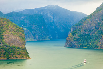 Obraz premium Cruise ship ferryboat on norwegian fjord