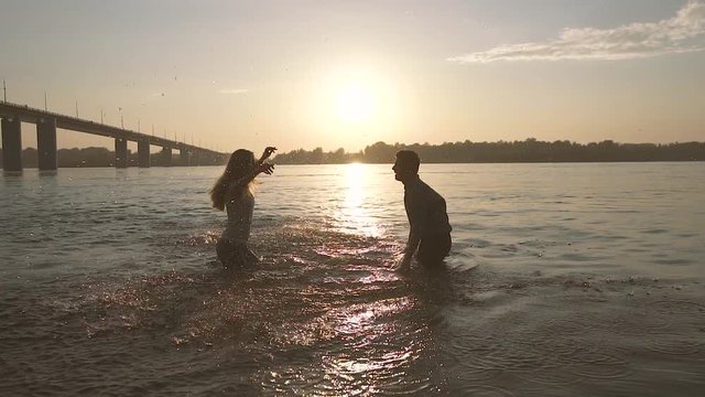 Two young people in love having fun with water