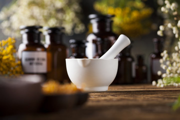 Herbs medicine,Natural remedy and mortar on vintage wooden desk