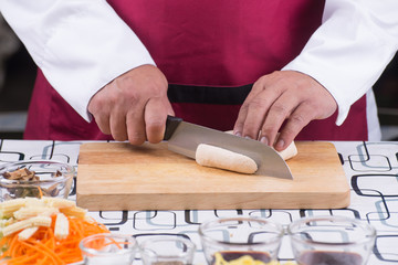 Obraz na płótnie Canvas Chef slicing tofu for cooking