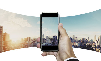 Businessman hand taking panoramic photo of Bangkok cityscape in sunrise