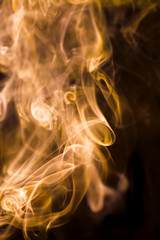 Gold smoke movement on black background.