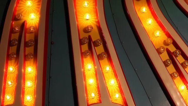 Lights from a sign animate.