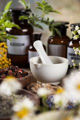 Natural medicine, herbs, mortar on wooden table background