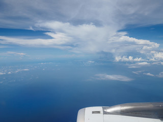 Clouds and sky as seen through window of an aircraft