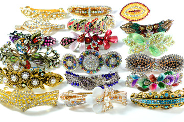 Colorful group of stone studded hair clips on a white background.