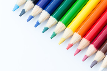 Sharpened colored pencils on a white background.