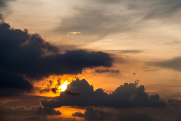 A stormy weather scene at sunset with raincloud