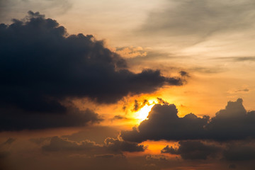 A stormy weather scene at sunset with raincloud