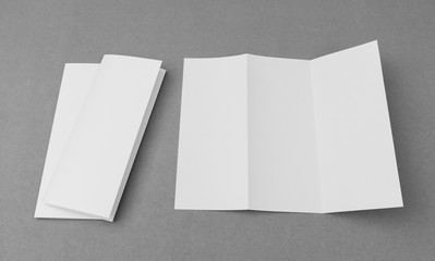 Trifold white template paper on gray  background .