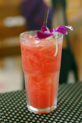 fresh watermelon shake with a straw and mint leaf. drink on table