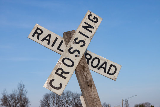 Railroad Crossing Sign Against Blue Sky