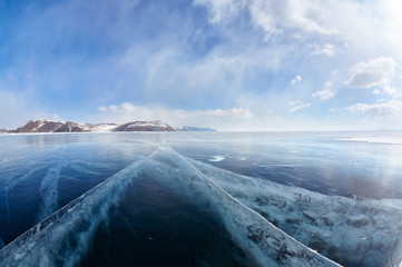 Naklejka premium Winter ice landscape on Siberian lake Baikal with clouds