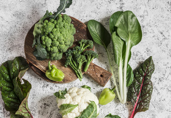 Fresh raw vegetables - broccoli, cauliflower, chard, peppers on a light background, top view