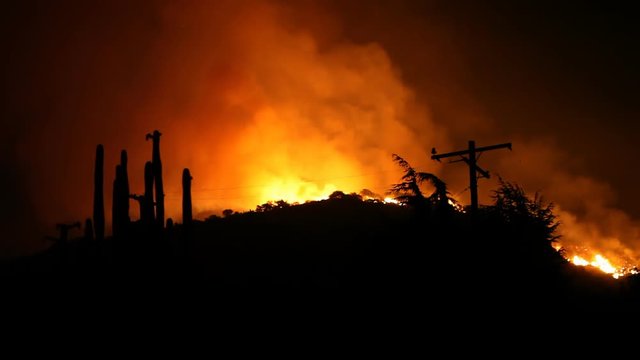 A raging hillside fire threatens a residential community.
