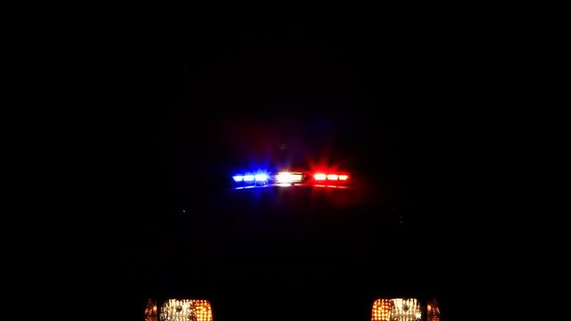 Isolated light bar and headlights of a police cruiser.