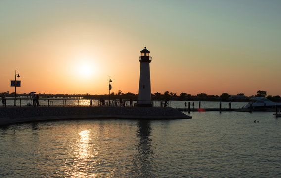 picture of boats pier lighthouse and lake in evening for backgro