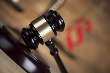 Law theme, mallet of the judge, wooden desk background