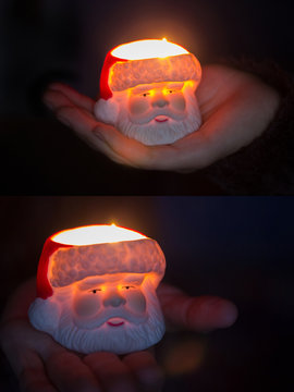 Burning candle with Santa Claus in hand