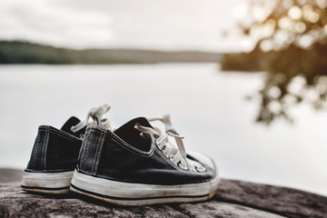 Black sneakers  on nature.Selective focus and hipster tone