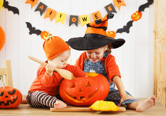 happy children cut a pumpkin for Halloween