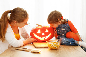 Fototapeta premium family mother and child daughter are preparing for Halloween car