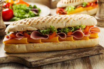 Traditional Italian sandwich with ham and cheese served warm.