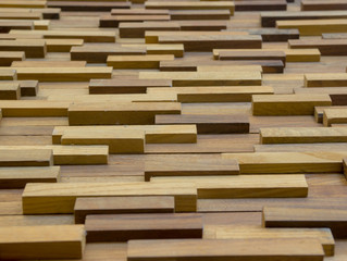 exposed wooden wall exterior, patchwork of raw wood forming a beautiful parquet wood pattern.(selected focus)
