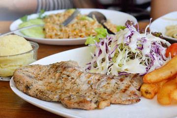 Fried pork chop, chips and vegetable salad