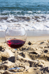 glass of red wine by the sea