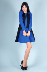 Beautiful young girl  posing on a blue background