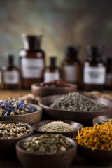 Herbs medicine and vintage wooden desk background