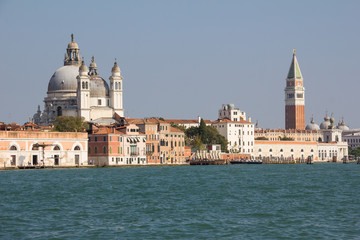 Fototapeta na wymiar Basilica Di Santa Maria Della Salute & Campanile Bell Tower At St. Mark's Square In Venice Italy 