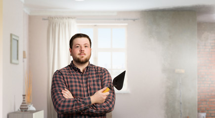 Handyman with tool in interior . Mixed media