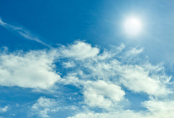 Sun  with blue sky and clouds