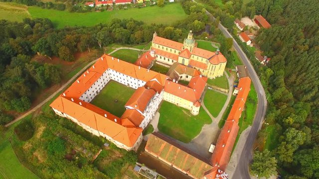 Camera flight over Benedictine monastery in Kladruby. Baroque architecture in Czech Republic. European landmarks from above.