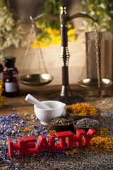 Healthy herbs on wooden table, mortar and herbal medicine