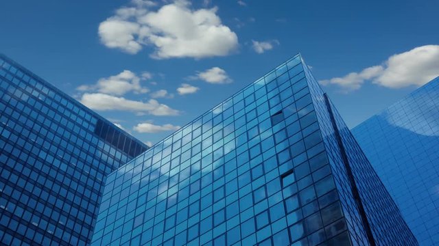 Modern office skyscrapers. Blue sky and clouds. Time lapse UHD