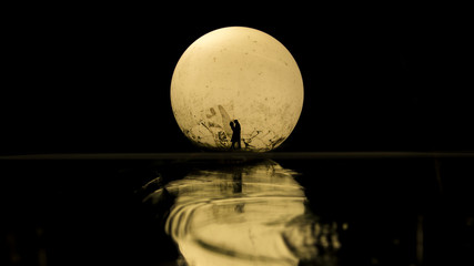 Silhouette of couple kissing under full moon