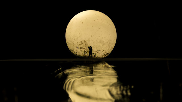 Silhouette Of Couple Kissing Under Full Moon