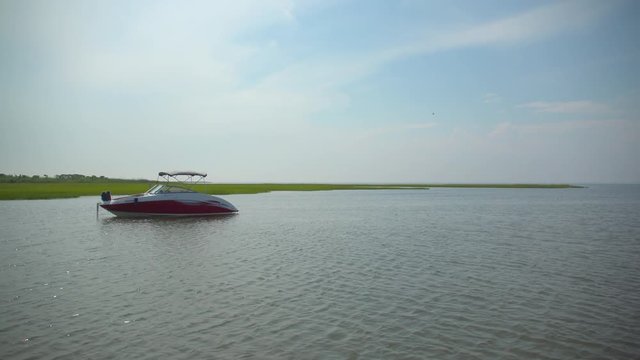 Luxury boat near the marsh and dock of Ho Hum beach on Fire Island