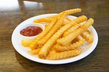 french fries with sauce on a wood background