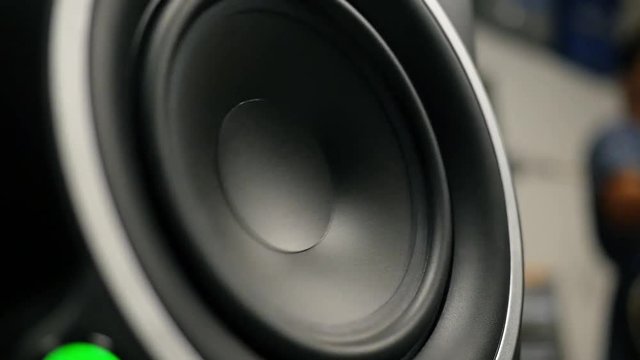 A close up of large subwoofer during garage band practice.