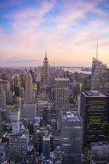 Fototapeta na wymiar Bright golden pink sunset view of the Midtown Manhattan New York City skyline looking south 