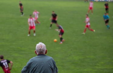 Fototapeta premium Old man watching football