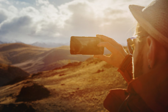 Man taking photo of mountains