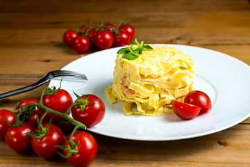 close-up of plate of pasta and smoked salmon with tomato