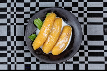 Sweet egg-banana  (Pisang mas) in syrup topped coconut milk